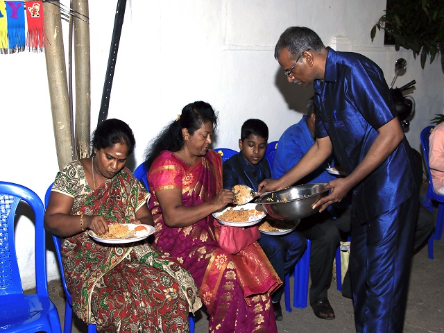 Tamil feeding two ladies in his new Church.