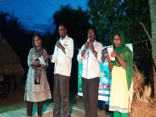 Tamil and his Pastor sharing the Gospel.